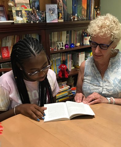 Student reading with tutor