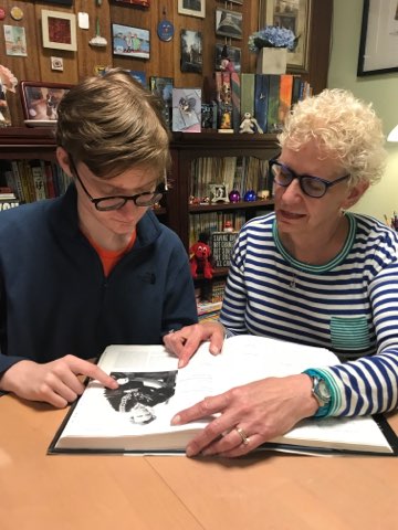 A student writing with Dr. Mazza.