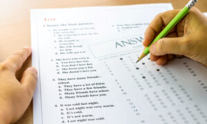 student completing test sheet and answer sheet